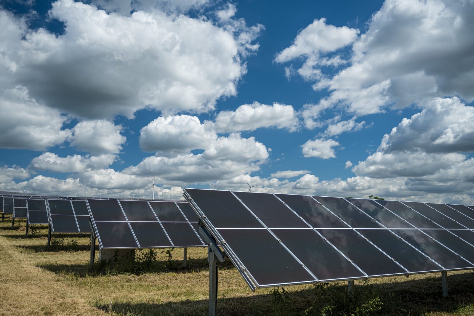 solar panels used renewable energy field sky full clouds scaled
